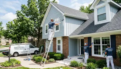 Professional house painters working on exterior home in Kansas City KS